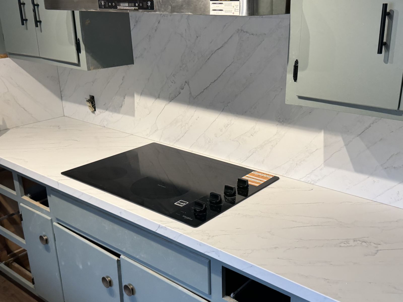 Marble-look quartz with full-height splash at the range — kitchen countertop installation