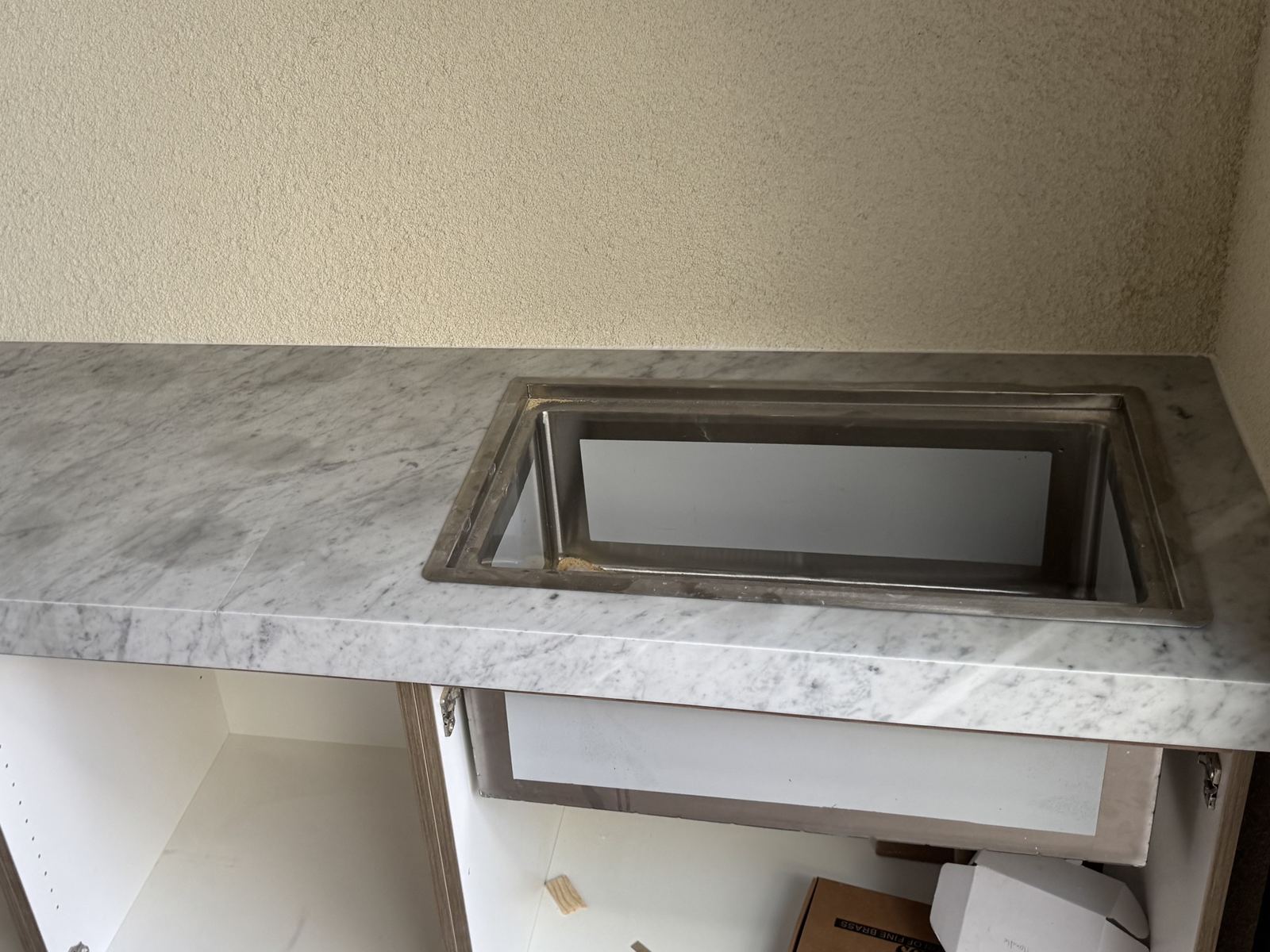Carrara marble vanity, stainless undermount sink — bathroom vanity countertop