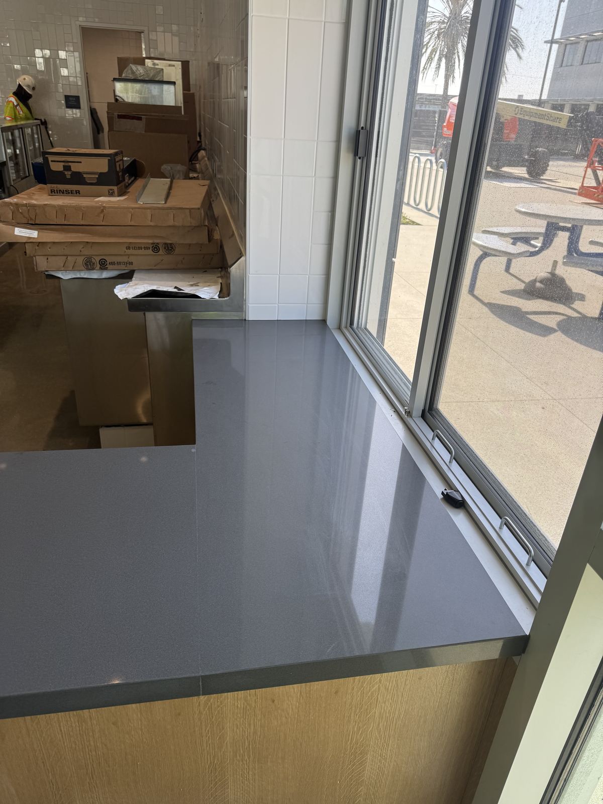 Gray quartz service counter, commercial kitchen — commercial countertop installation